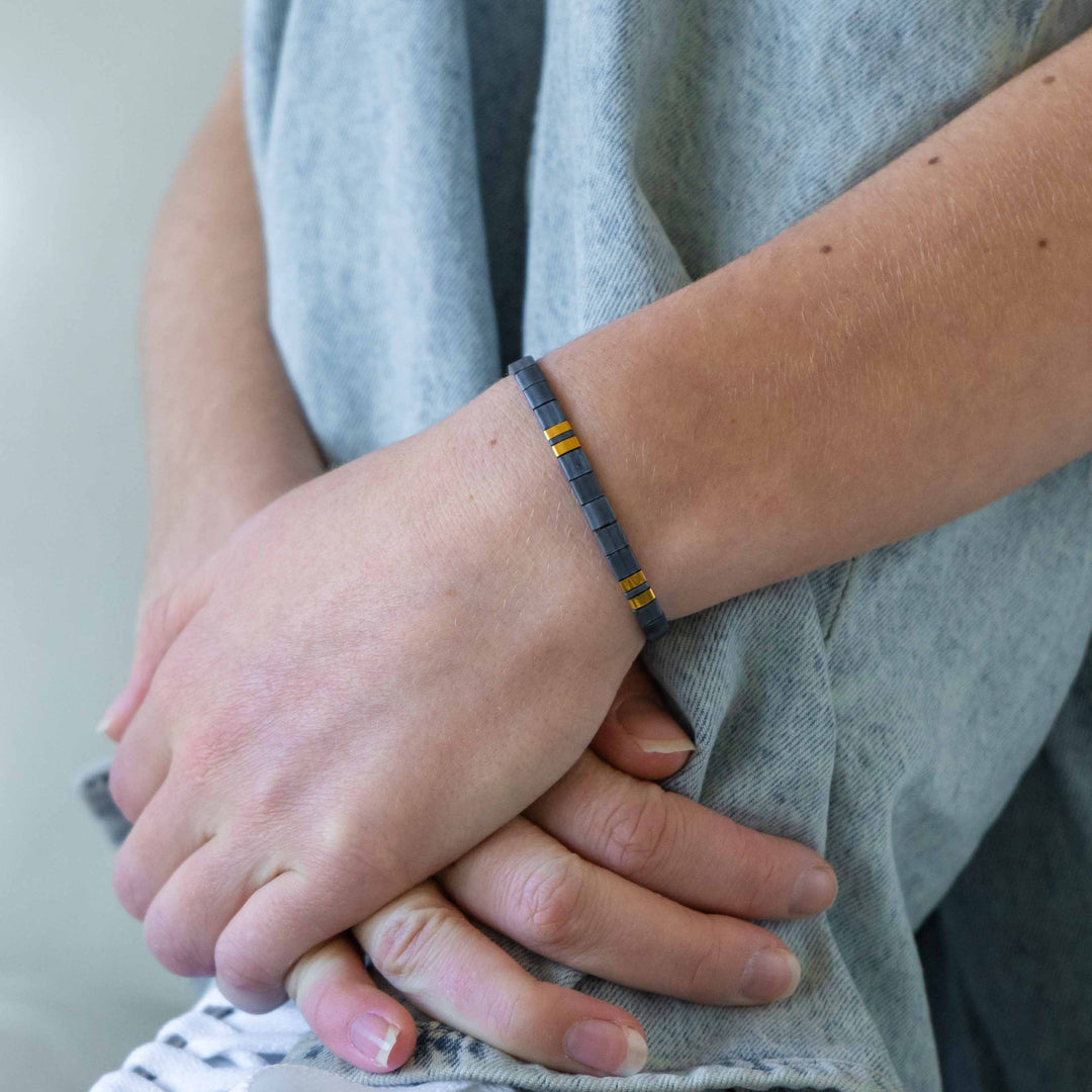 a person with a bracelet on their wrist