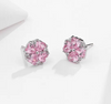 a pair of pink earrings on a white surface