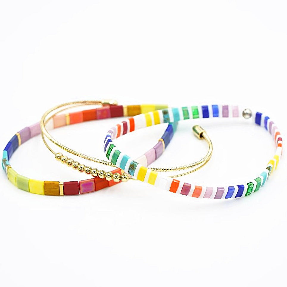 a couple of bracelets that are on a white surface