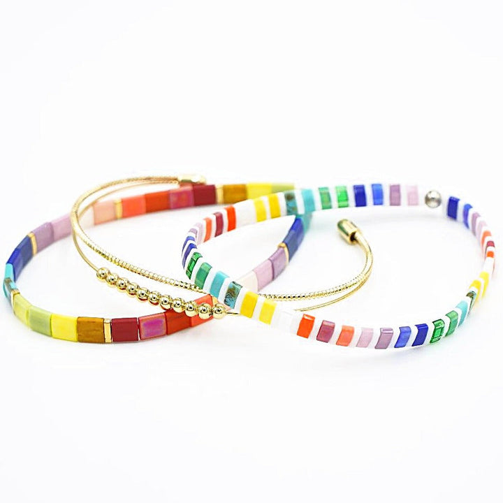 a couple of bracelets that are on a white surface