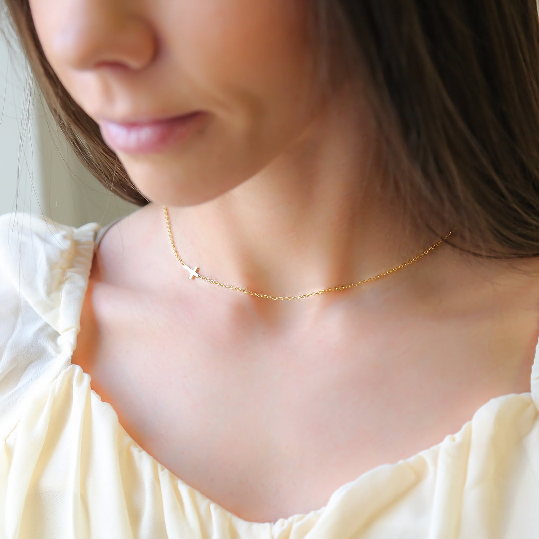 a close up of a woman wearing a necklace