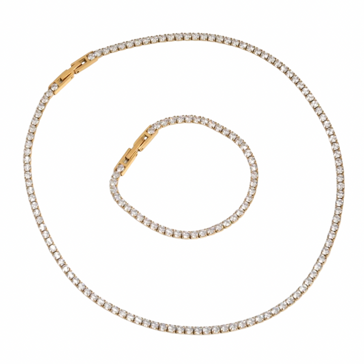 a gold and diamond necklace on a white background