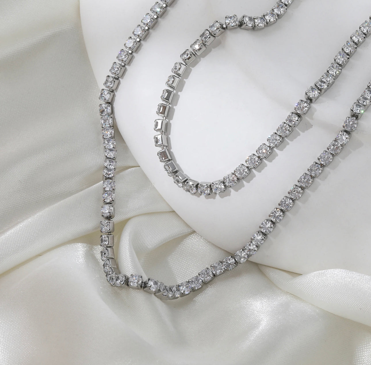 a diamond necklace and bracelet on a mannequin