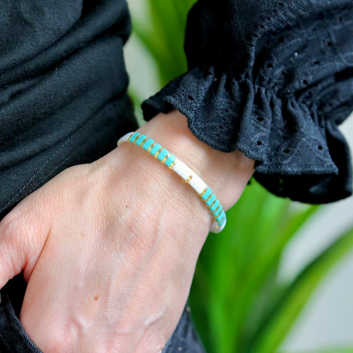 a woman's hand with a bracelet on it