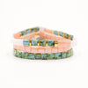 a stack of three bracelets with turquoise and pink beads