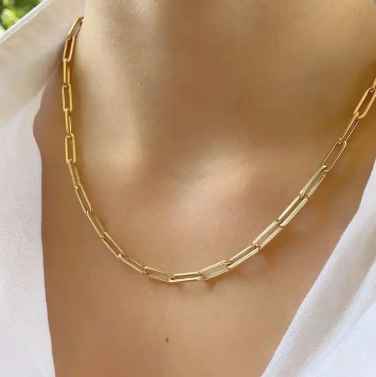 a woman wearing a gold chain necklace