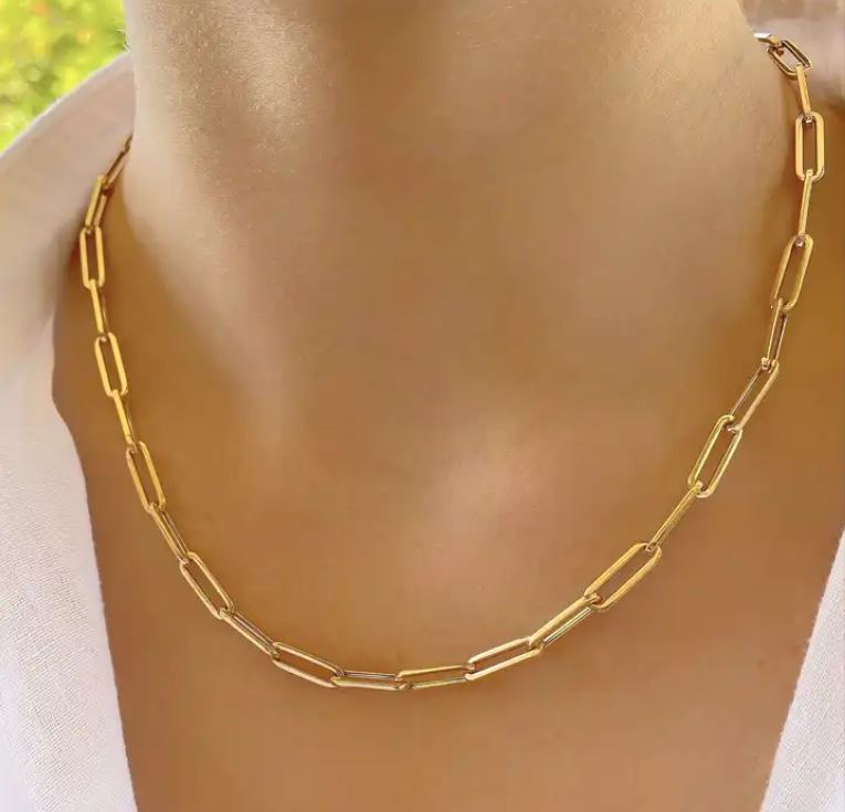 a woman wearing a gold chain necklace