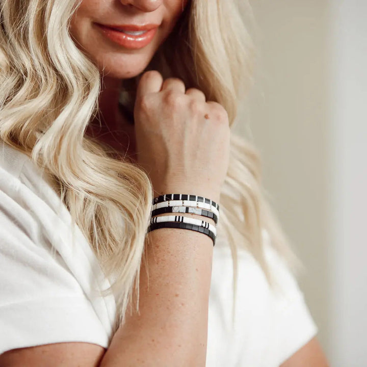a woman with blonde hair wearing a bracelet