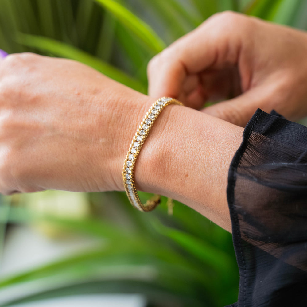 a woman's arm with a bracelet on it