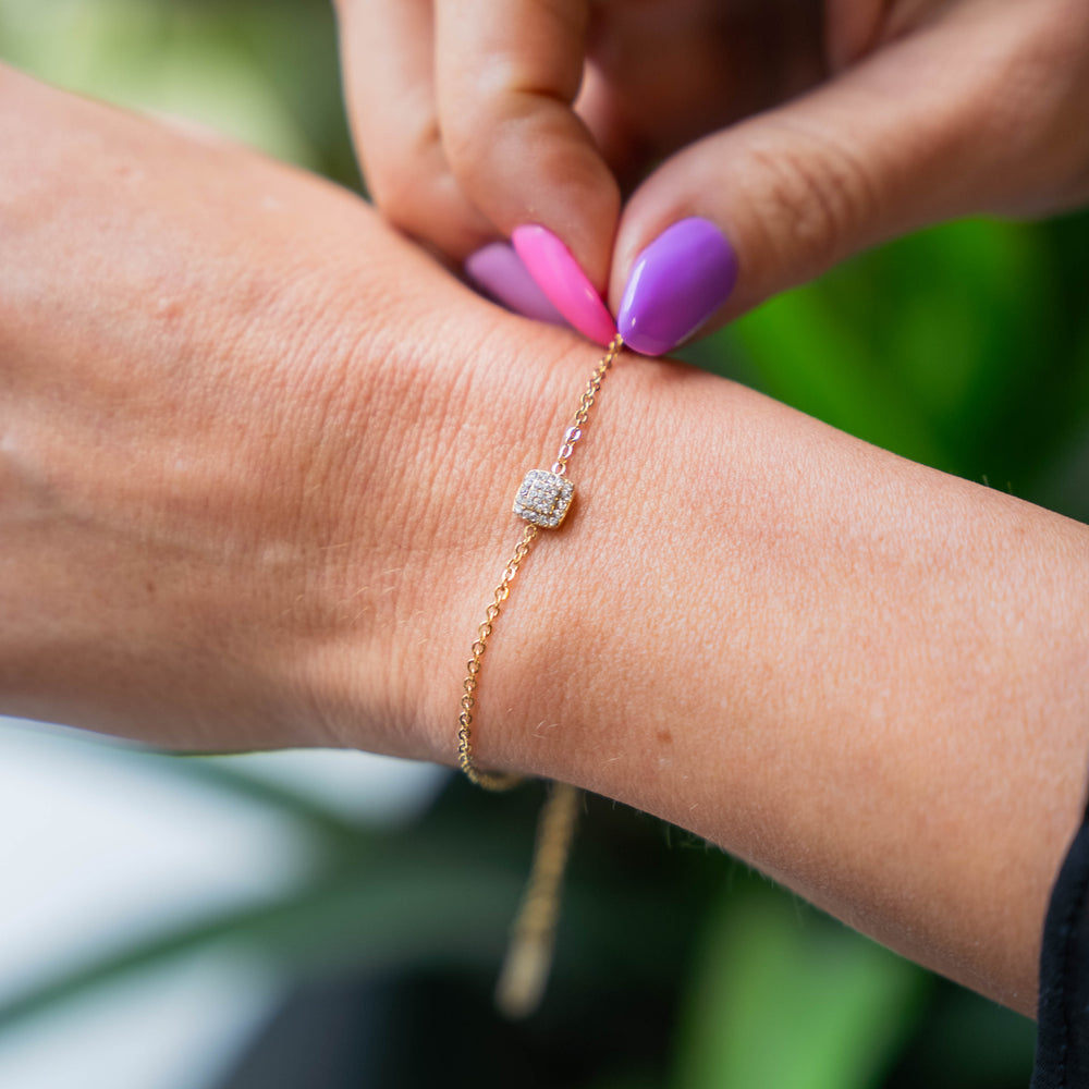 a woman's arm with a pink and purple manicure on it