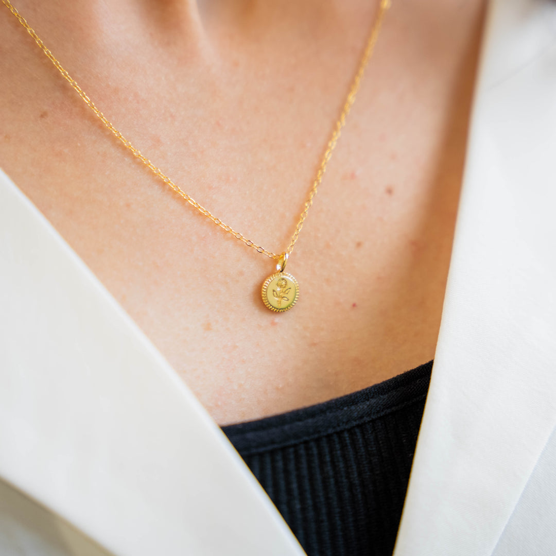 a close up of a person wearing a necklace