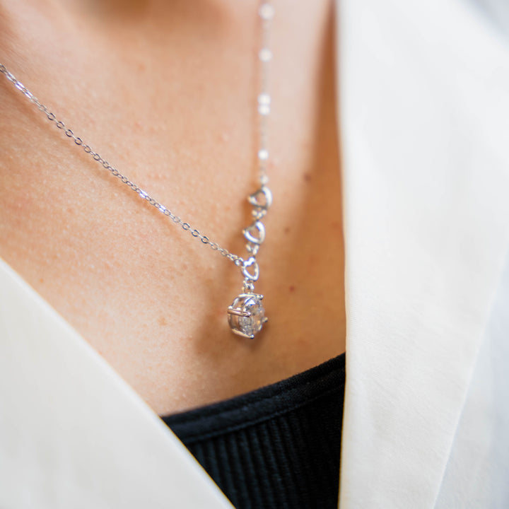 a close up of a woman wearing a necklace