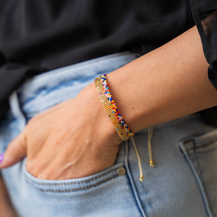 a woman wearing a bracelet and a black shirt