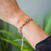 a person wearing a colorful beaded bracelet