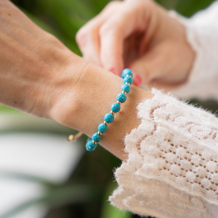 a close up of a person wearing a bracelet