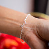 a person wearing a chain bracelet on their arm