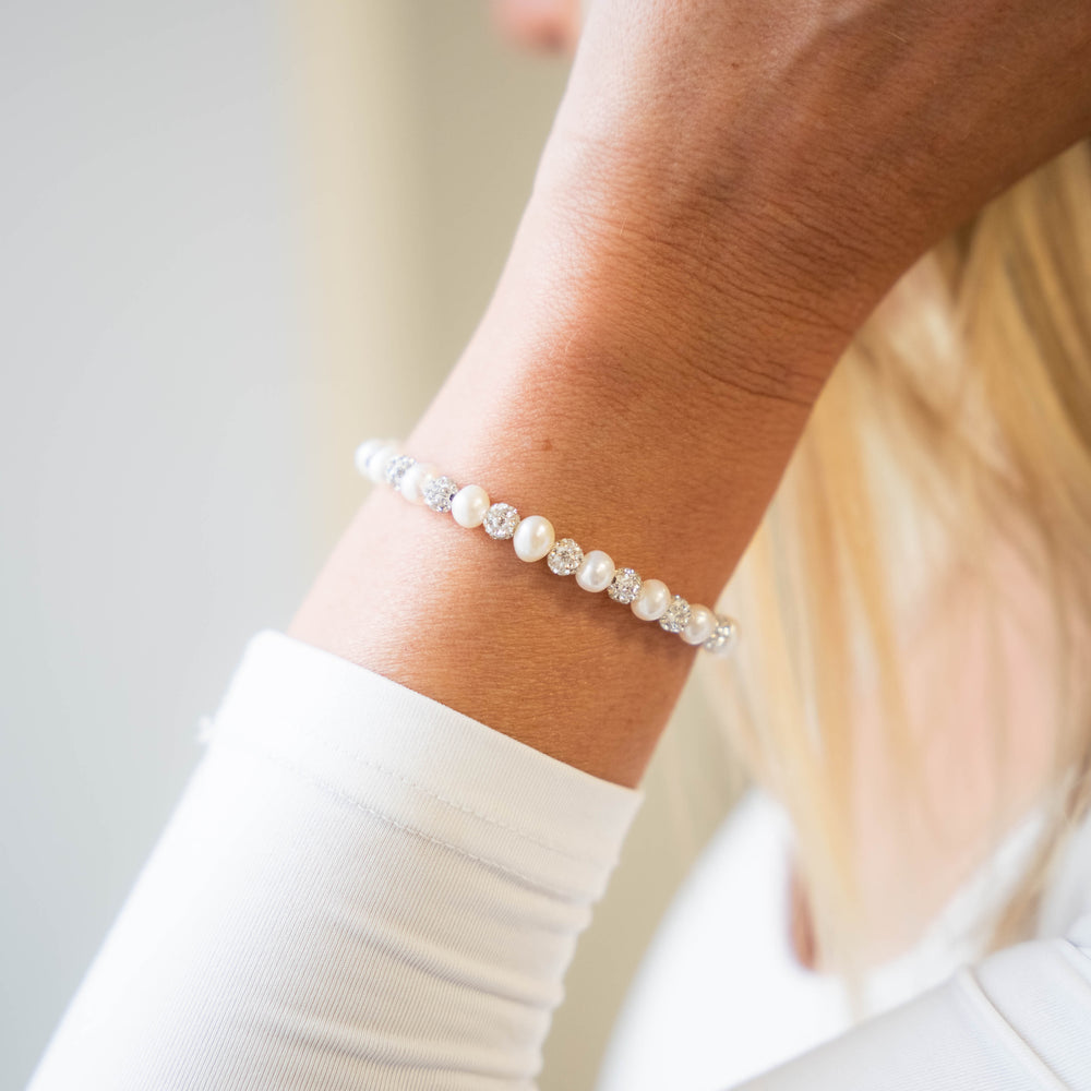 a close up of a person wearing a bracelet