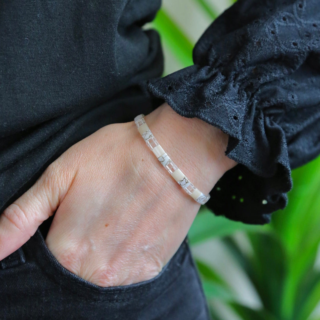 a woman's hand with a bracelet on it