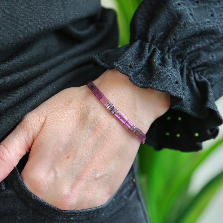 a woman's hand with a bracelet on it