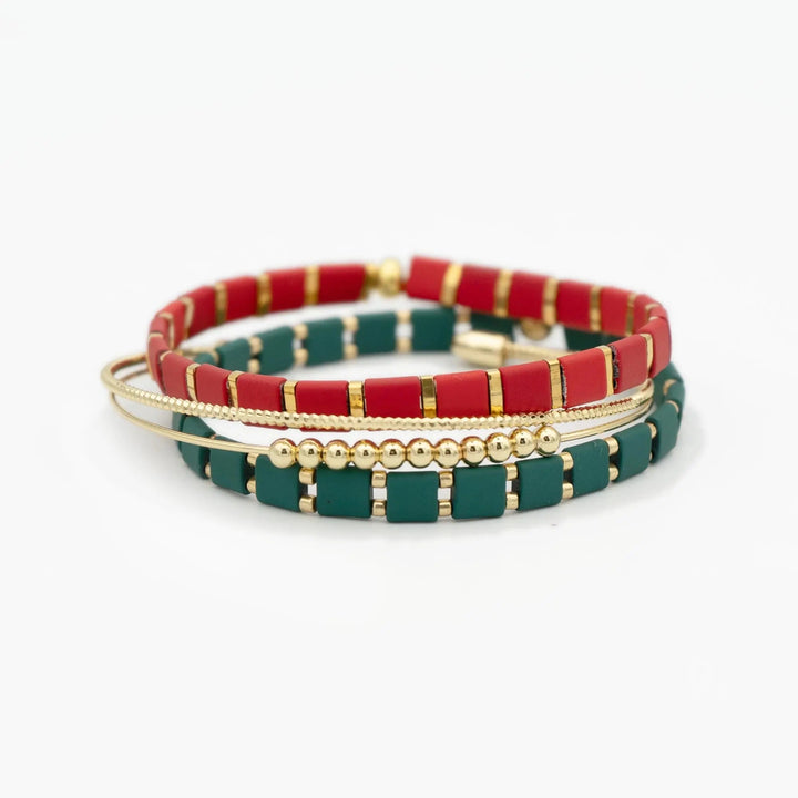 a pair of red and green bracelets on a white background