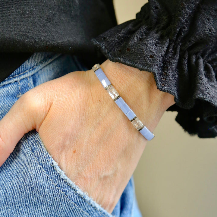 a woman's hand with a bracelet on it