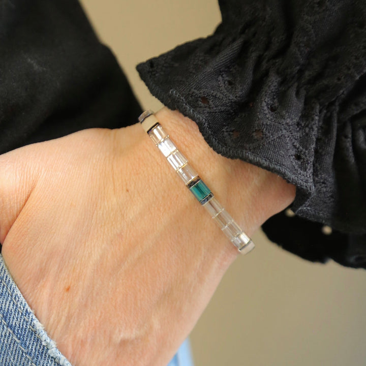 a woman's hand with a bracelet on it