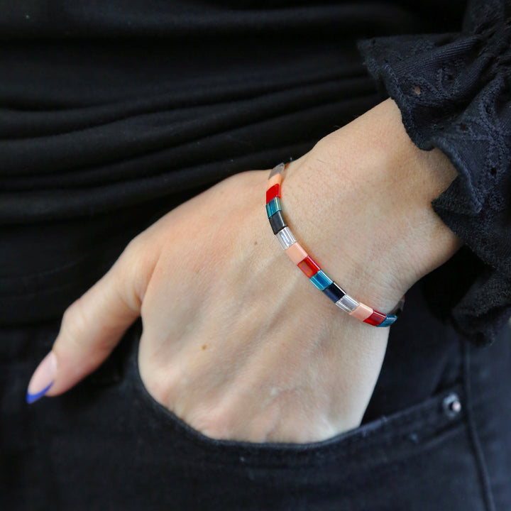 a woman's hand with a bracelet on it